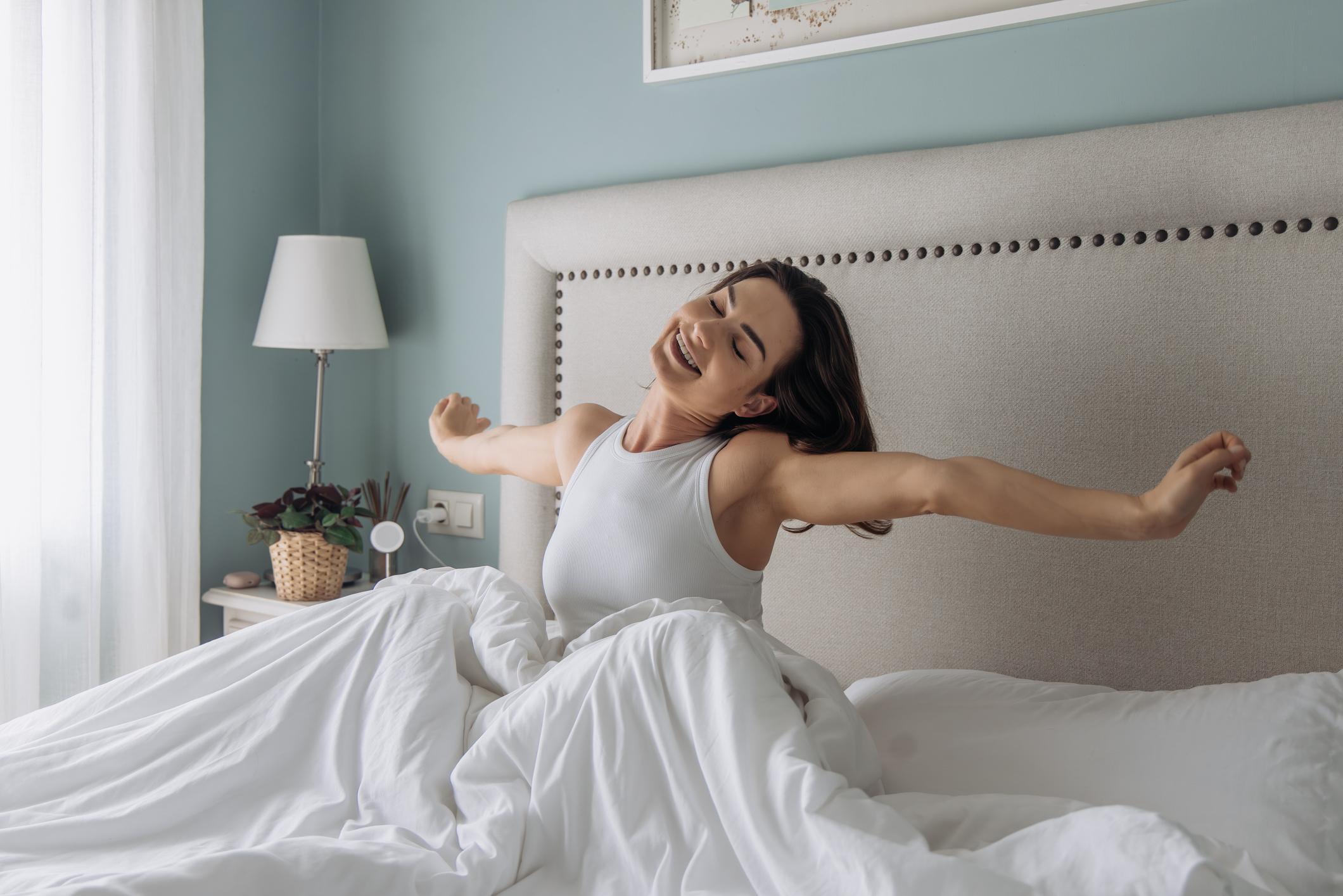 Woman Stretching After Restful Sleep Woman Stretching After Restful Sleep